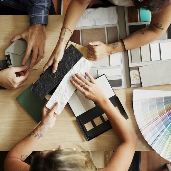Interior designer discussing tile and color options with clients in her office